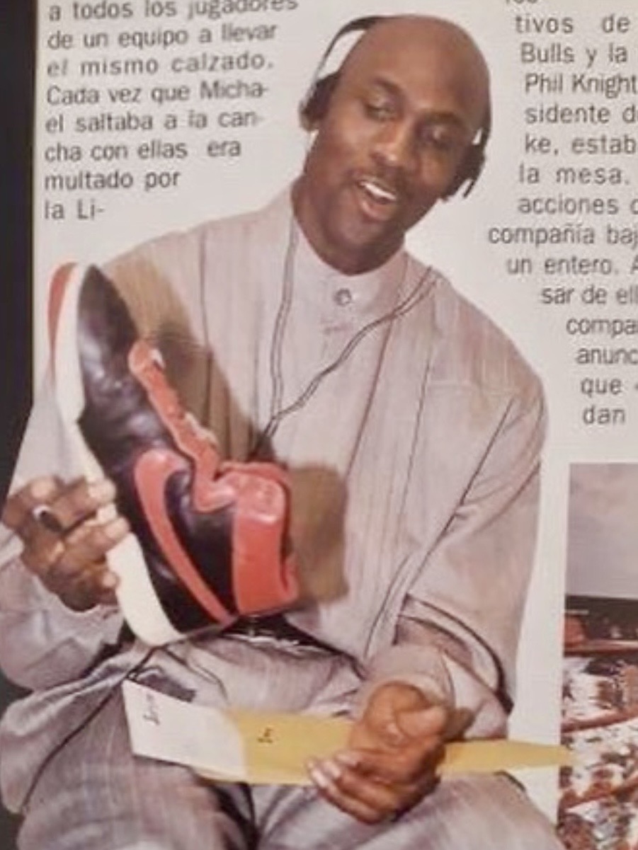 Michael Jordan holding black and red Nike Air Ship without laces, 1993
