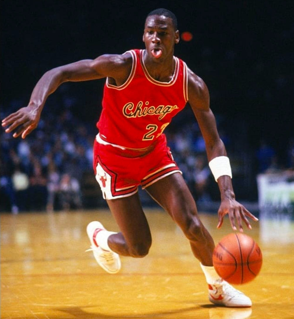 Michael Jordan wearing white and red Nike Air Ship sample against the Milwaukee Bucks on October 13, 1984