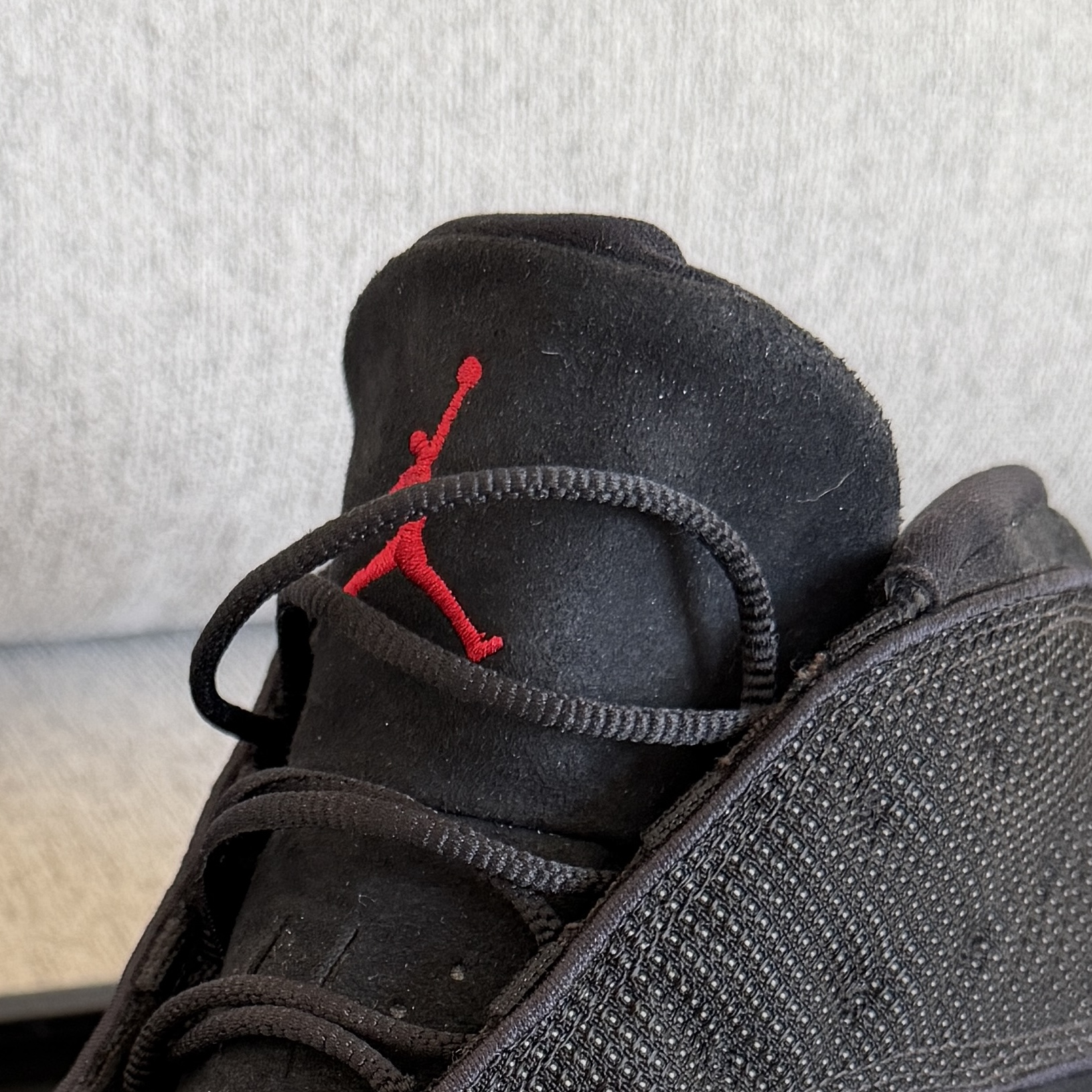 Corresponding upper tongue edge and red Jordan logo on the physical shoe